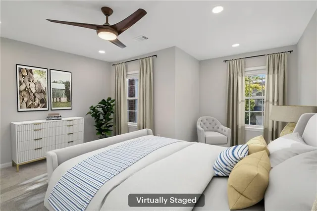 a bedroom with a large bed and a window