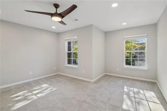 a view of a livingroom with a ceiling fan and window