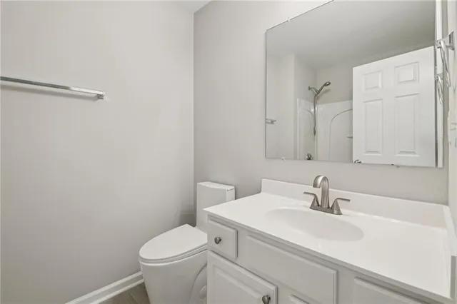 a bathroom with a sink toilet and a mirror