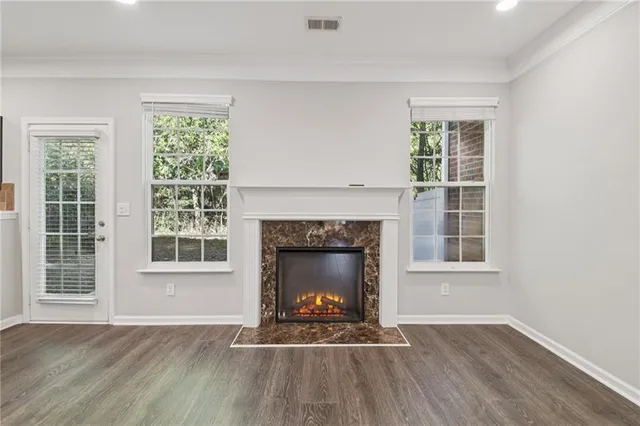 a living room with wooden floors and a fireplace