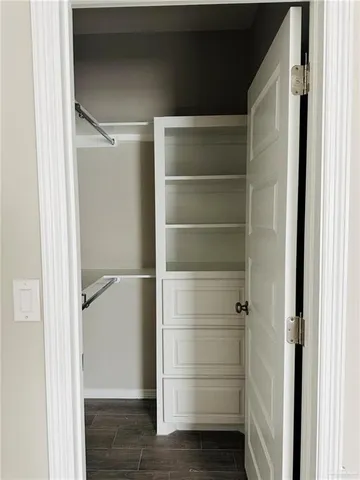 an empty room with closet and fan