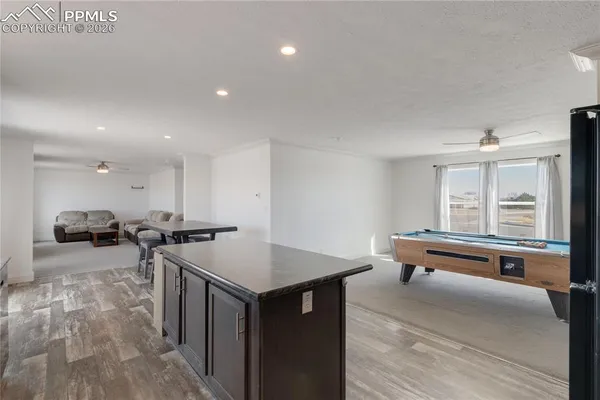 a kitchen with stainless steel appliances kitchen island granite countertop a table and chairs in it