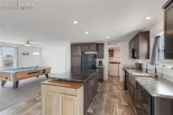a kitchen with stainless steel appliances granite countertop a sink counter space and cabinets