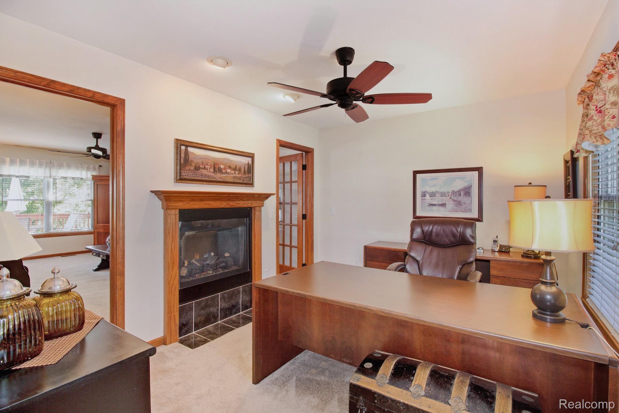 1113 South Hacker Road Brighton, MI 48114 - Photo 13 of 35 Formal dining room/office with two-way fireplace.