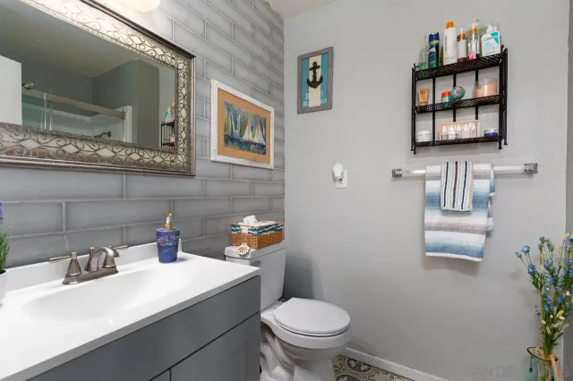 a bathroom with a sink mirror and toilet