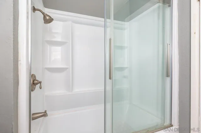 a bathroom with a glass shower door