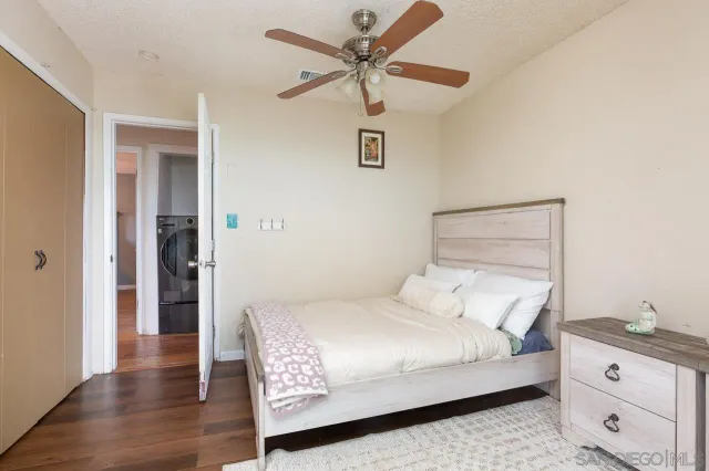 a bedroom with a bed and a ceiling fan