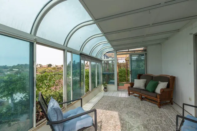 a living room with furniture and a floor to ceiling window