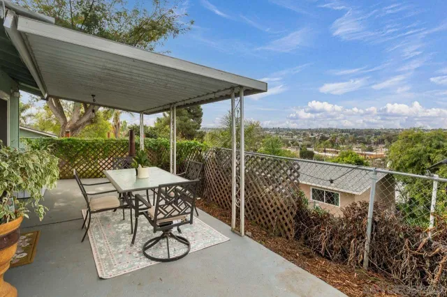 a patio with table and chairs