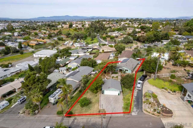 an aerial view of residential houses with outdoor space