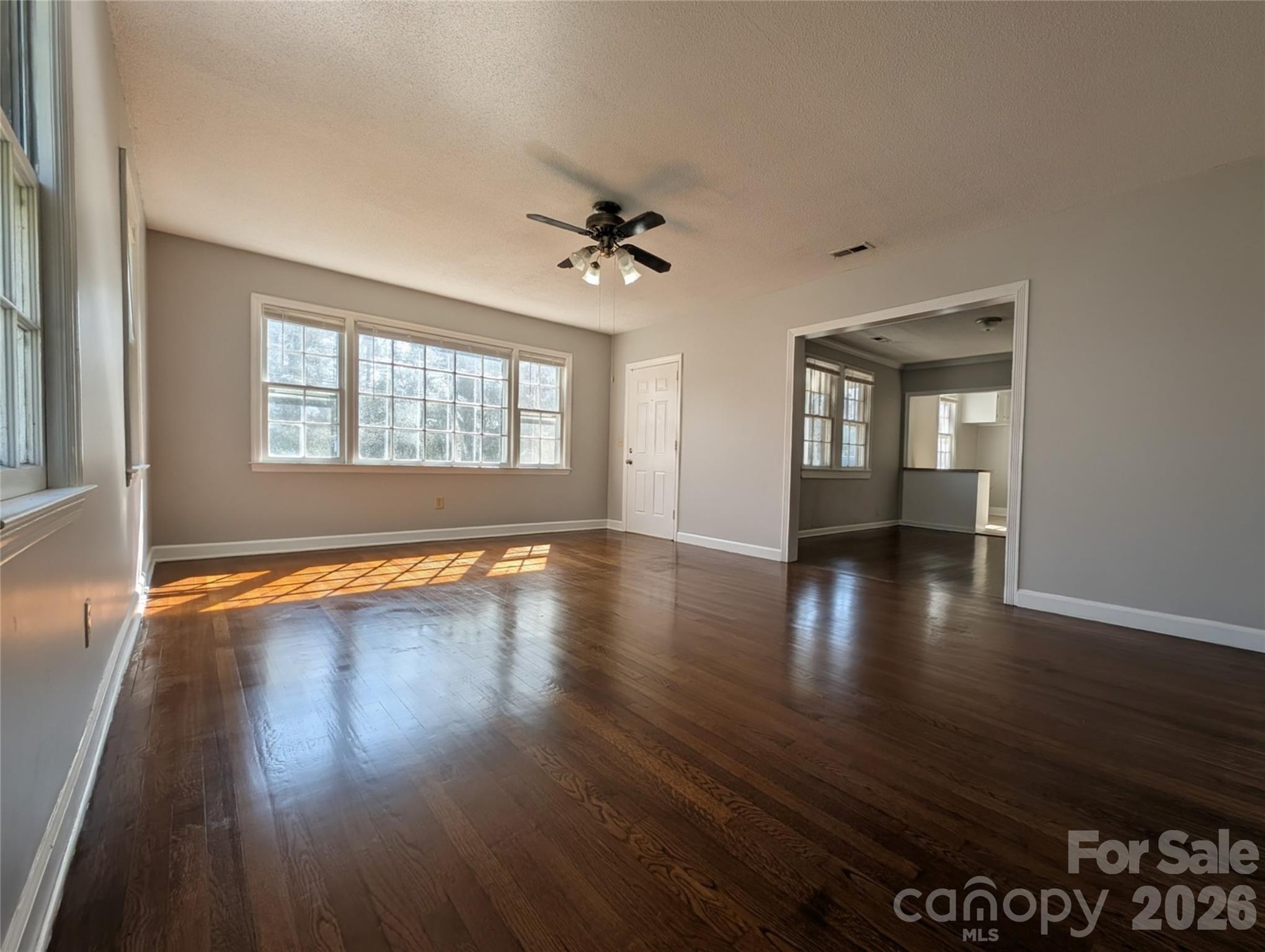 118 Brown Street Lake City, SC 29560 - Photo 1 of 12 an empty room with wooden floor and windows