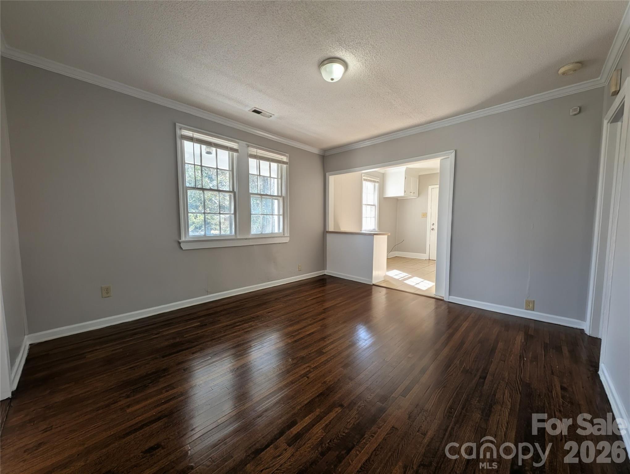 118 Brown Street Lake City, SC 29560 - Photo 3 of 12 an empty room with wooden floor and windows