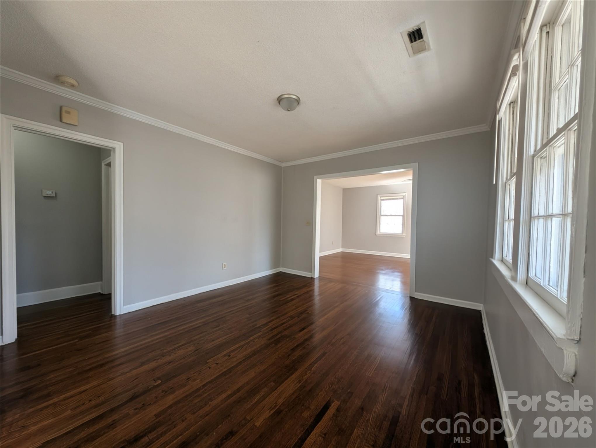 118 Brown Street Lake City, SC 29560 - Photo 4 of 12 an empty room with wooden floor and windows