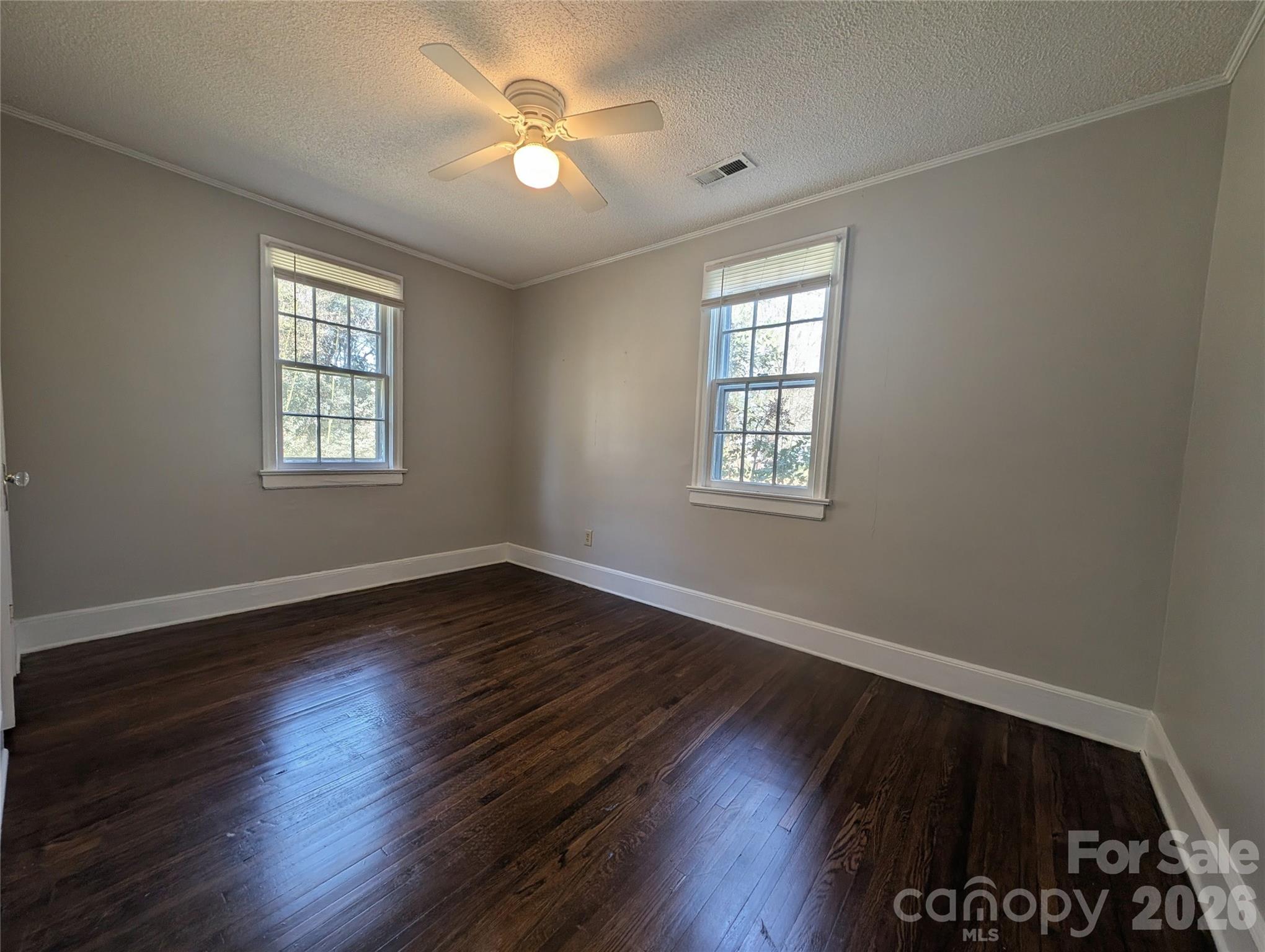 118 Brown Street Lake City, SC 29560 - Photo 6 of 12 a view of an empty room with wooden floor and a window