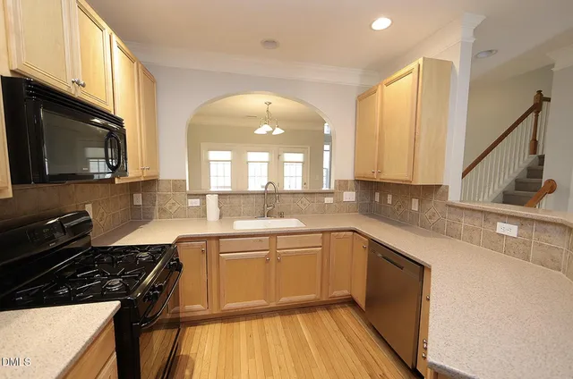 a kitchen with a sink stove and cabinets