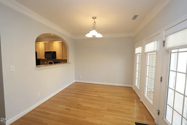 a view of a room with wooden floor and windows