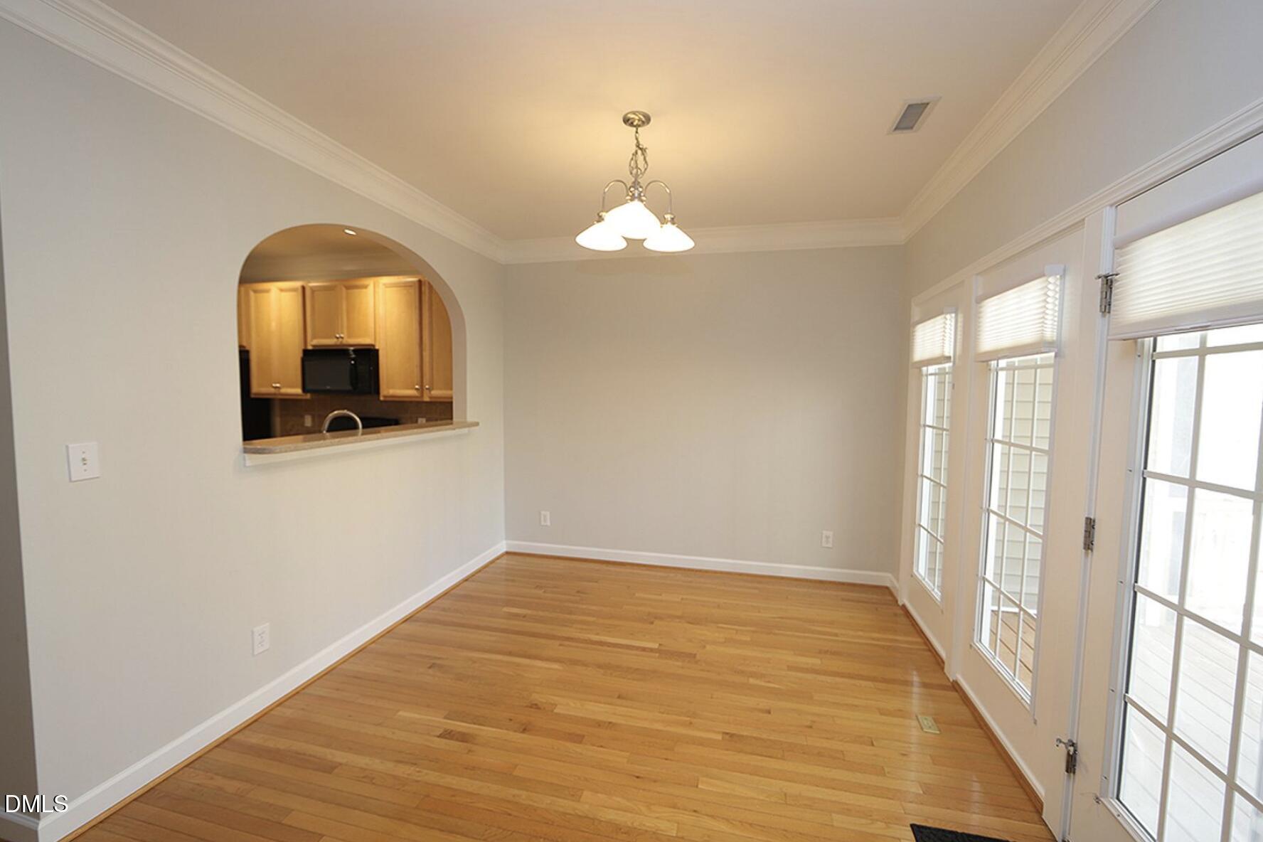 5947 Four Townes Lane Raleigh, NC 27616 - Photo 6 of 13 a view of a room with wooden floor and windows