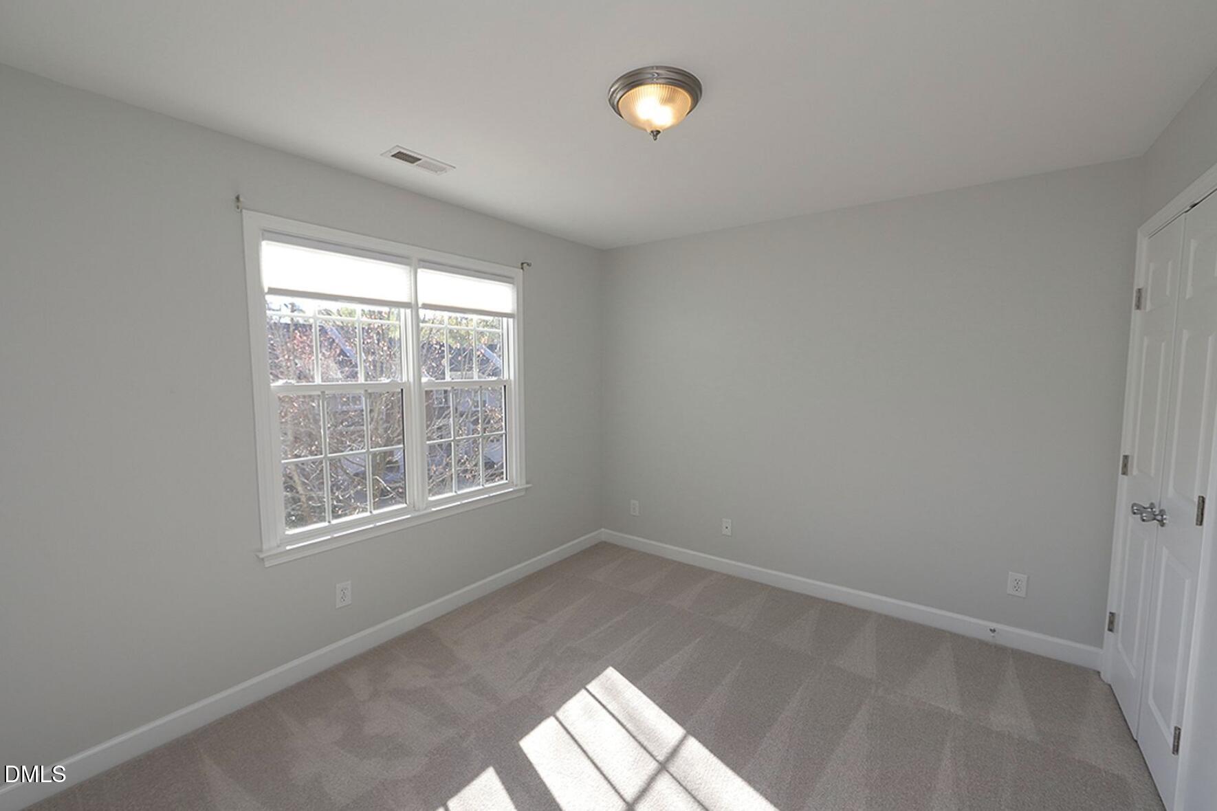 5947 Four Townes Lane Raleigh, NC 27616 - Photo 9 of 13 an empty room with a window