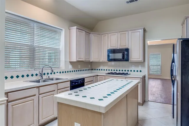 a utility room with cabinets and washer dryer