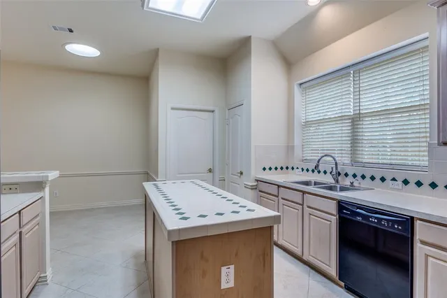 a kitchen with a stove sink and refrigerator