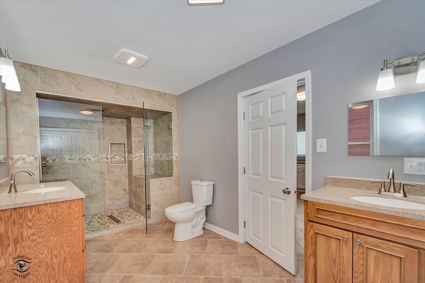 1032 South E Avenue Kankakee, IL 60901 - Photo 13 of 29 a spacious bathroom with a granite countertop sink a toilet a mirror and shower