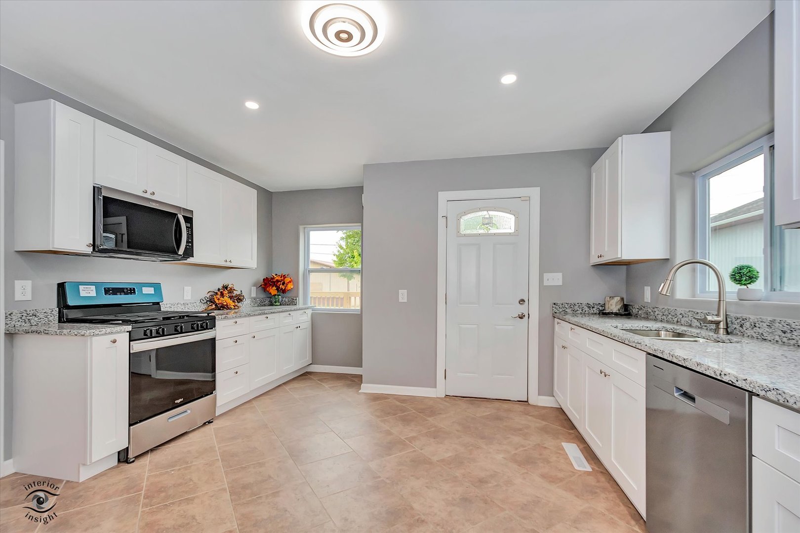 1032 South E Avenue Kankakee, IL 60901 - Photo 6 of 29 a kitchen with a sink stove top oven and cabinets