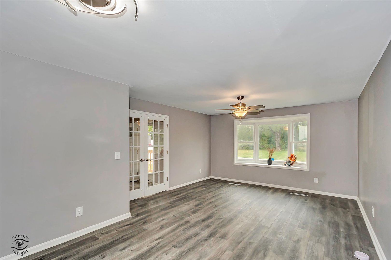 1032 South E Avenue Kankakee, IL 60901 - Photo 10 of 29 an empty room with wooden floor and windows
