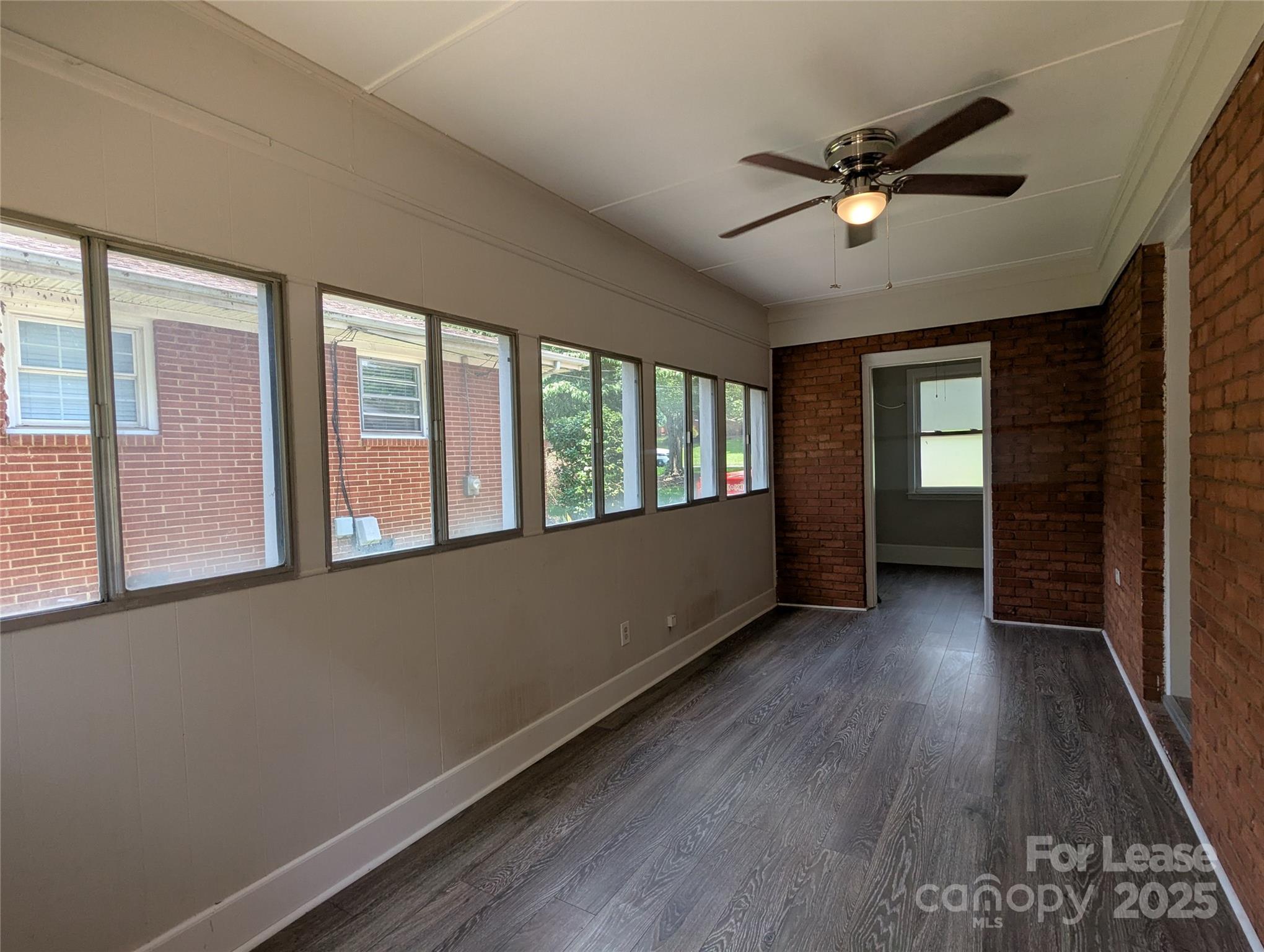 1614 Keeling Place Charlotte, NC 28210 - Photo 12 of 17 a view of an empty room with a window and wooden floor