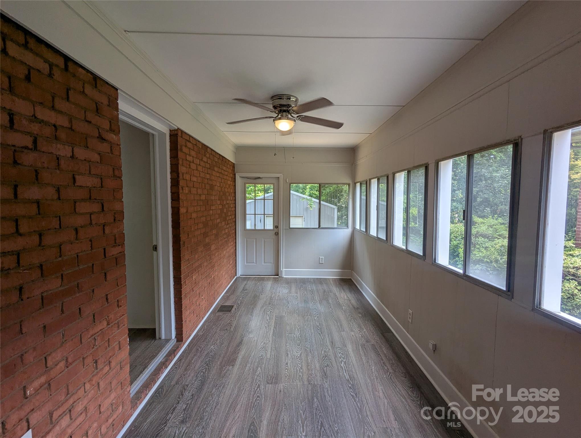 1614 Keeling Place Charlotte, NC 28210 - Photo 13 of 17 a view of hallway with wooden floor and chandelier