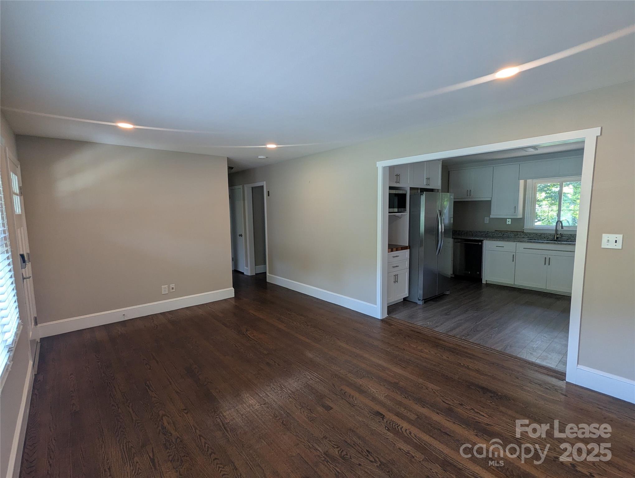 1614 Keeling Place Charlotte, NC 28210 - Photo 5 of 17 an empty room with wooden floor and windows