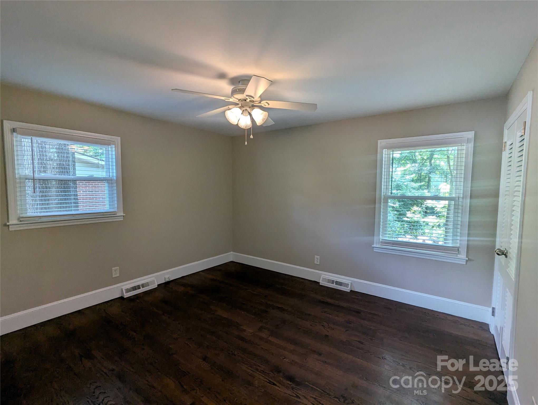 1614 Keeling Place Charlotte, NC 28210 - Photo 10 of 17 a view of empty room with wooden floor and fan