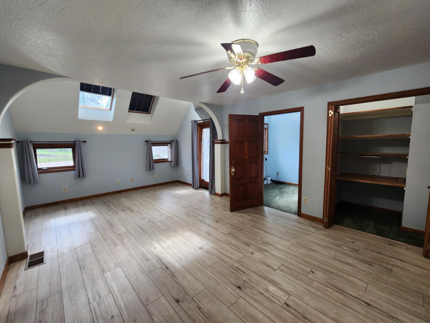 19500 Jesus Maria Road Mokelumne Hill, CA 95245 - Photo 19 of 92 a view of an empty room with a window and wooden floor