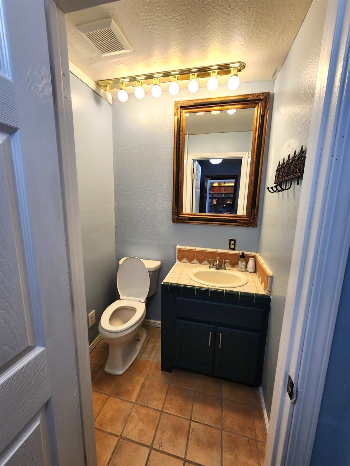 19500 Jesus Maria Road Mokelumne Hill, CA 95245 - Photo 21 of 92 a bathroom with a granite countertop sink and a mirror