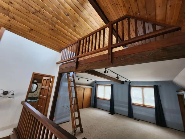 an empty room with fan and a fireplace