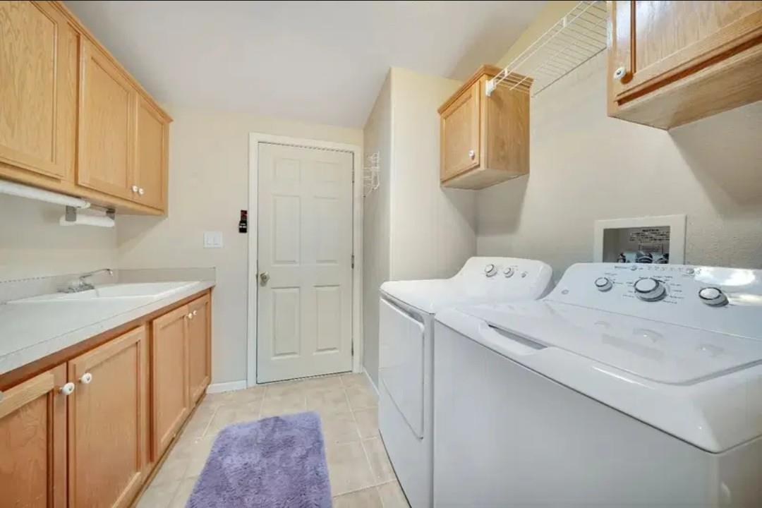 19500 Jesus Maria Road Mokelumne Hill, CA 95245 - Photo 77 of 92 a utility room with cabinets washer and dryer