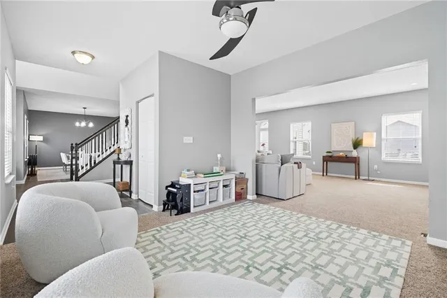 a living room with furniture a dining table and chairs with wooden floor