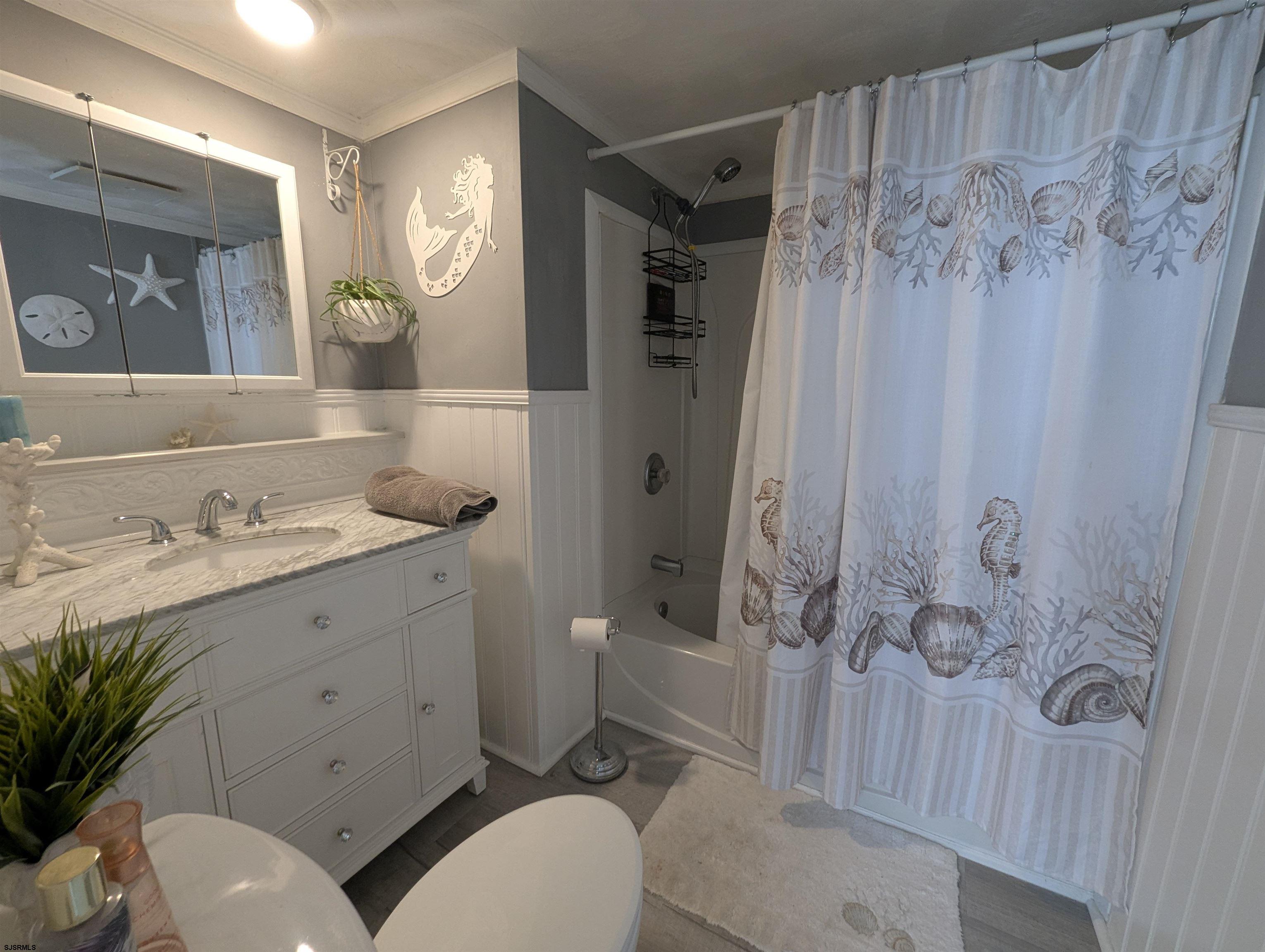430 South Shore Road Marmora, NJ 08223 - Photo 14 of 21 a bathroom with a granite countertop sink toilet a mirror a vanity and shower