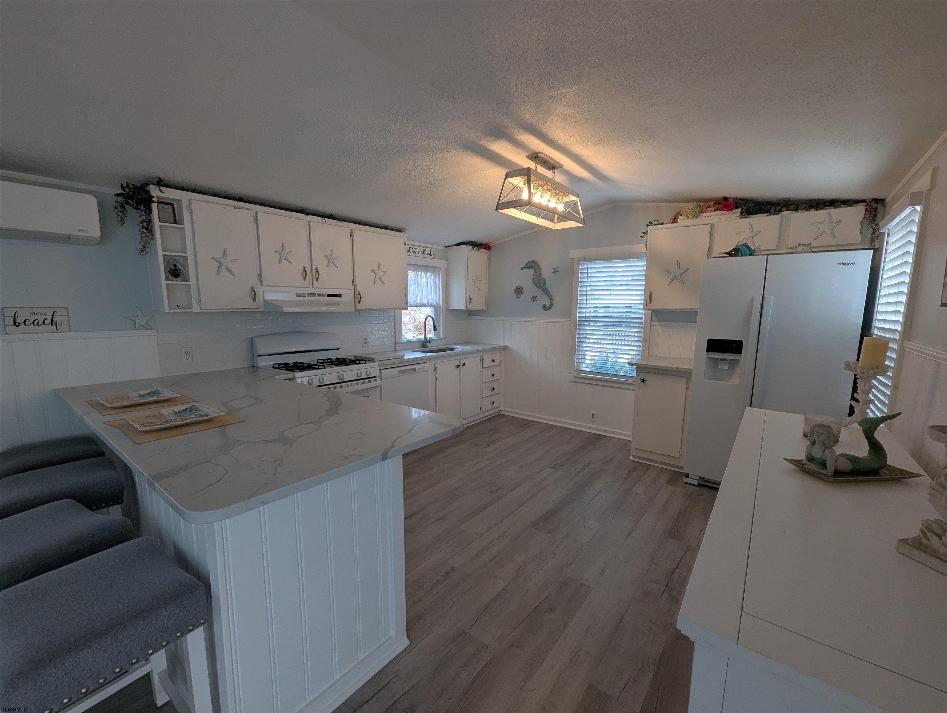 430 South Shore Road Marmora, NJ 08223 - Photo 5 of 21 a kitchen with stainless steel appliances a stove a sink a refrigerator and cabinets