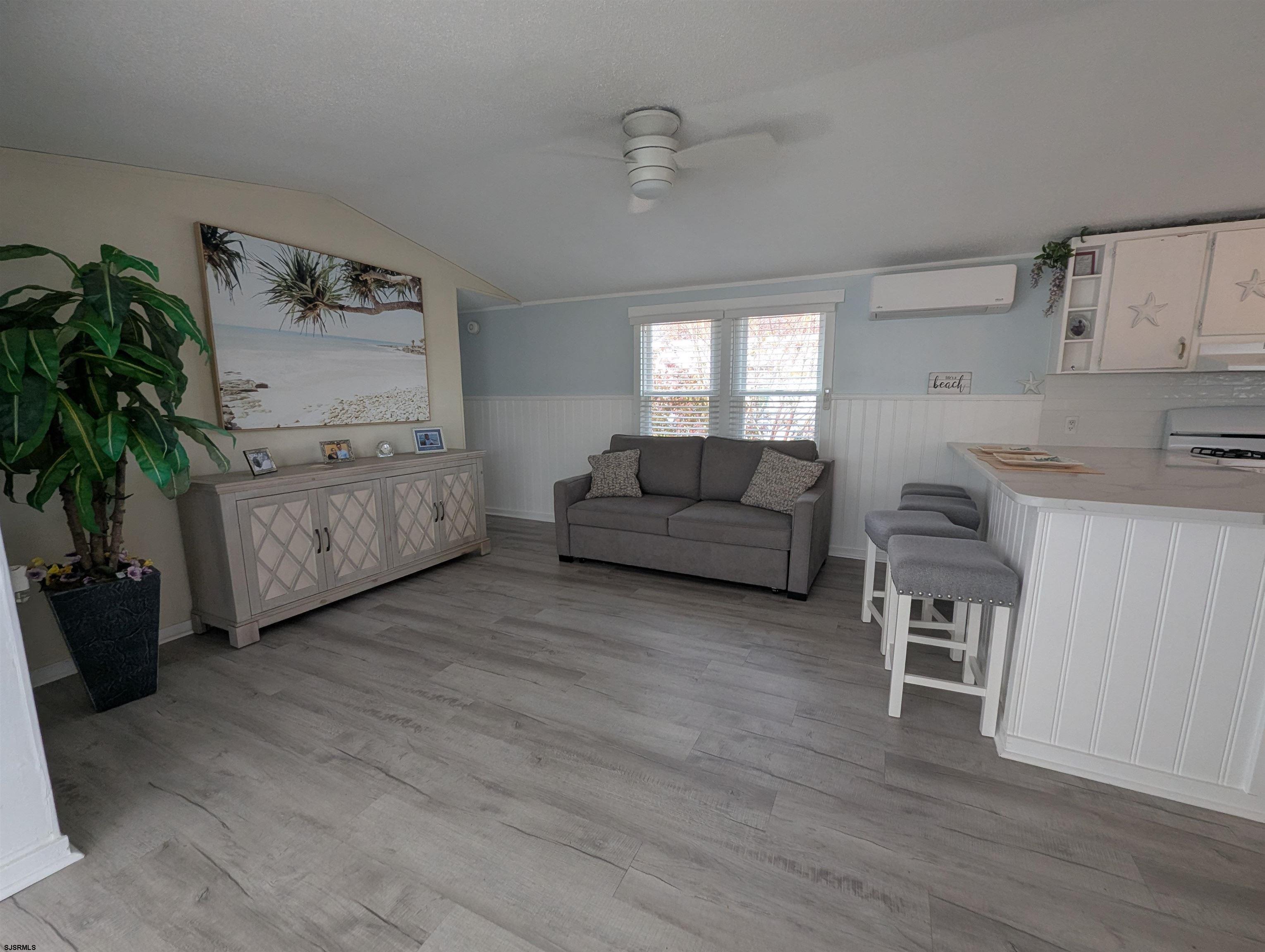 430 South Shore Road Marmora, NJ 08223 - Photo 10 of 21 a living room with furniture and a potted plant