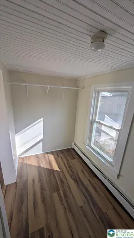 a view of an empty room and wooden floor