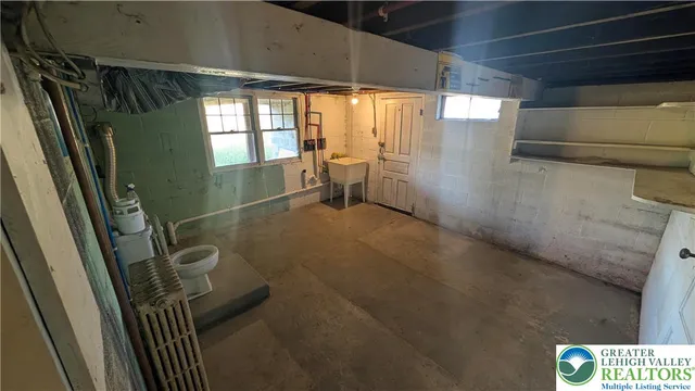 a view of a room with wooden floor and windows