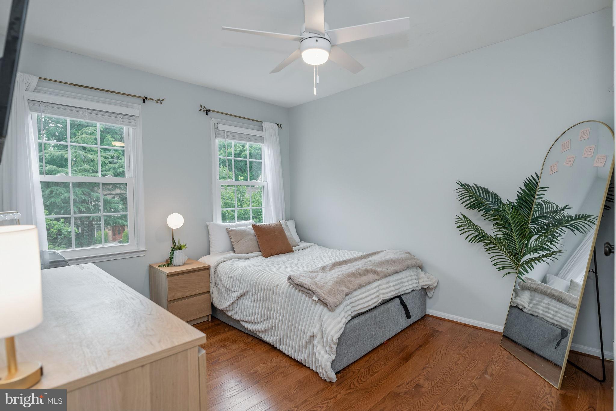 7603 Modisto Lane Springfield, VA 22153 - Photo 29 of 57 a bedroom with a bed and a potted plant
