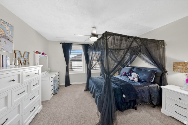 14738 Tangle Hill Road Herriman, UT 84096 - Photo 35 of 66 Carpeted room with a ceiling fan, light gray wall paint, and a window with blinds and dark curtains