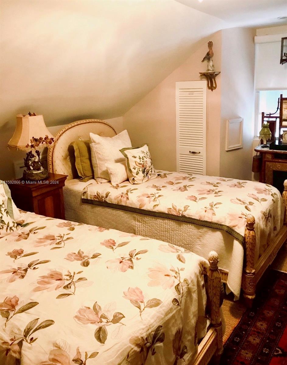 8420 Southwest 70th Street Miami, FL 33143 - Photo 11 of 20 a bedroom with a bed and a chandelier