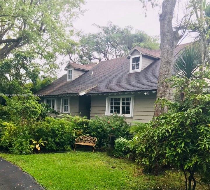 8420 Southwest 70th Street Miami, FL 33143 - Photo 19 of 20 a front view of a house with a yard