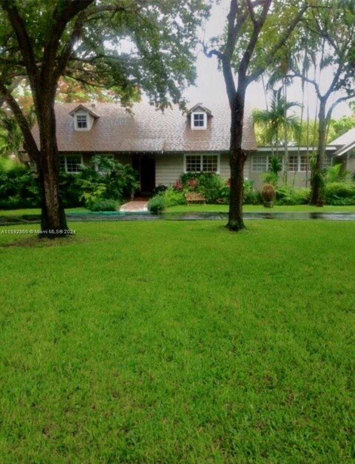 8420 Southwest 70th Street Miami, FL 33143 - Photo 20 of 20 a front view of a house with garden