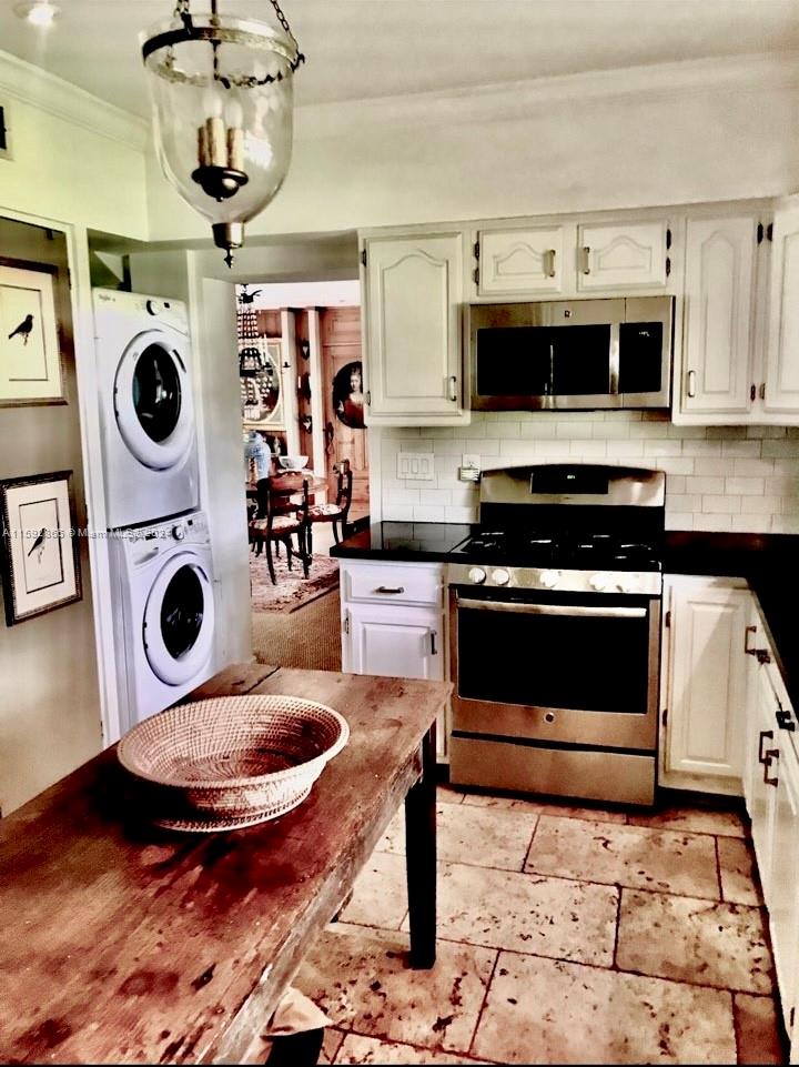 8420 Southwest 70th Street Miami, FL 33143 - Photo 7 of 20 a kitchen with a stove a microwave and cabinets