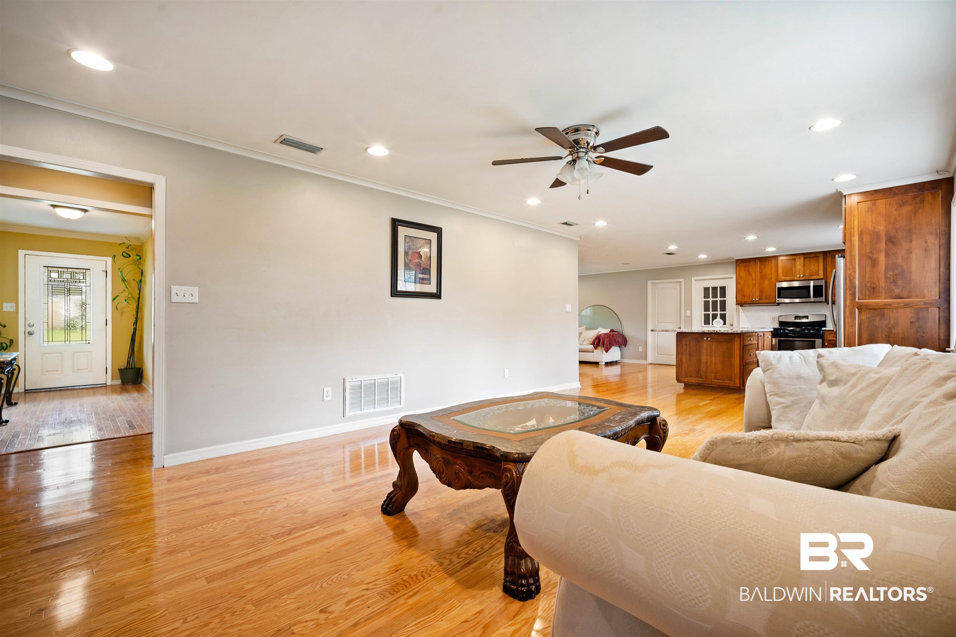 627 Spanish Main Spanish Fort, AL 36527 - Photo 7 of 39 Living area featuring visible vents, light wood-style flooring, and a ceiling fan