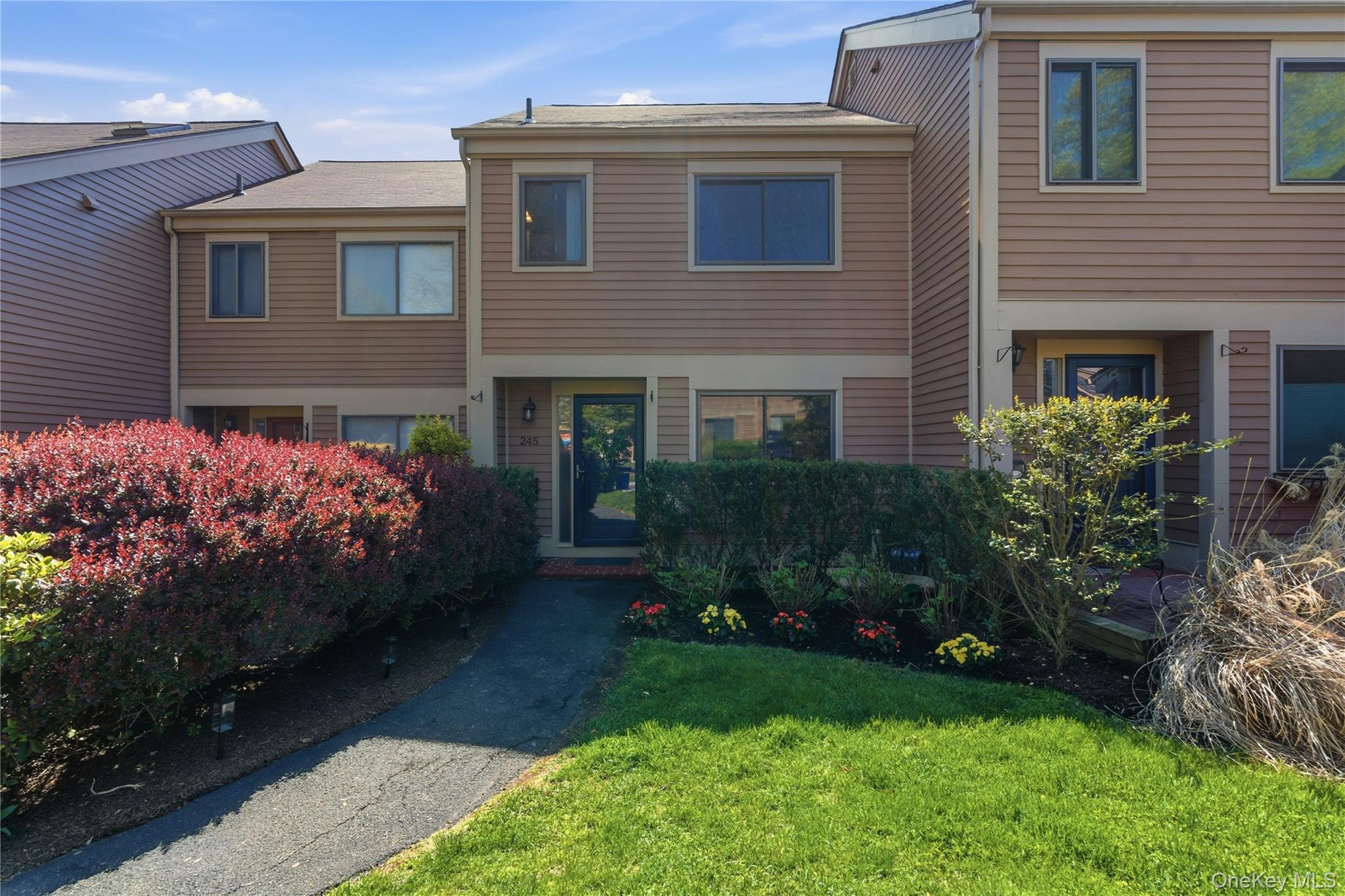 245 Tree Top Crescent Rye Brook, NY 10573 - Photo 2 of 24 a front view of a house with a garden