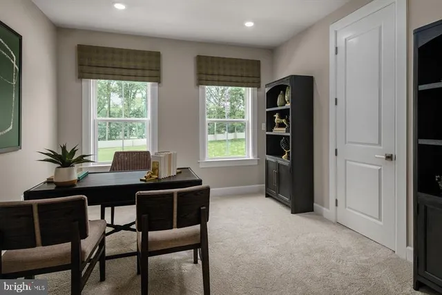 a view of a workspace with a window and dining table